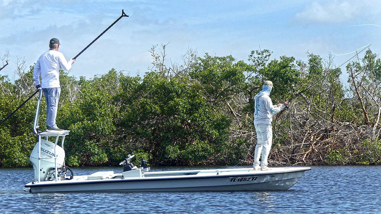 Fly fishing guide poling shallow water near Boca Grande