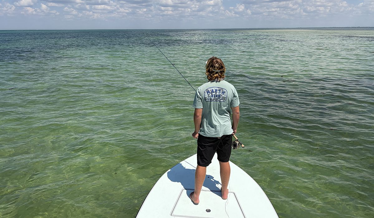 Fly fishing guide poling a skiff near Charlotte Harbor and Boca Grande